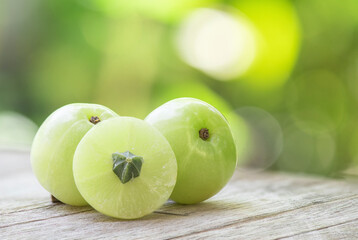 Indian Gooseberry or phyllanthus emblica fruits on nature background.