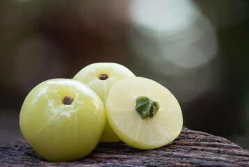Indian Gooseberry or phyllanthus emblica fruits on nature background.