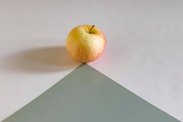 red apple on gray triangle