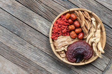 Ginseng, lingzhi mushroom, goji berry, red jujube and tea on  an old wooden background.top view,flat lay.