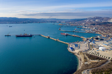 Fototapeta na wymiar Aerial view of the town and the port on sunny winter day. Novorossiysk, Krasnodar Krai, Russia.