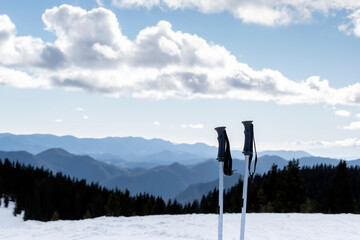 Downhill skiing, winter holidays and mountain resort vacations. Ski poles and background of wide...