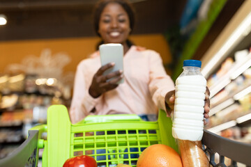 African American Customer Lady Using Phone Buying Milk In Supermarket