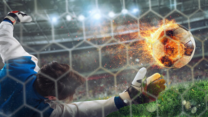 Goalkeeper catches a fast fiery soccer ball