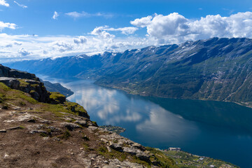 Fototapeta na wymiar Hiking the famous Dronningstien (the Queen’s route). Stunning view of the Sørfjord, Hardangerfjord and Folgefonna glacier from the Hardangervidda plateau, Hardanger, Norway.