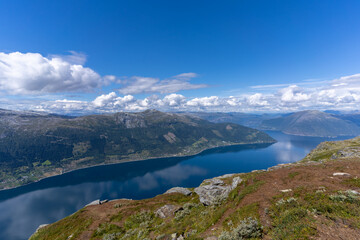 Naklejka na ściany i meble Hiking the famous Dronningstien (the Queen’s route). Stunning view of the Sørfjord, Hardangerfjord and Folgefonna glacier from the Hardangervidda plateau, Hardanger, Norway.