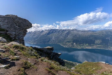 Fototapeta na wymiar Hiking the famous Dronningstien (the Queen’s route). Stunning view of the Sørfjord, Hardangerfjord and Folgefonna glacier from the Hardangervidda plateau, Hardanger, Norway.