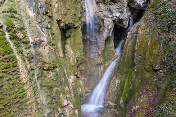 Fototapeta na wymiar View of Grotto waterfall in Teshebs river gorge on winter day. Gebiusskie waterfalls, Krasnodar Krai, Caucasus, Russia.