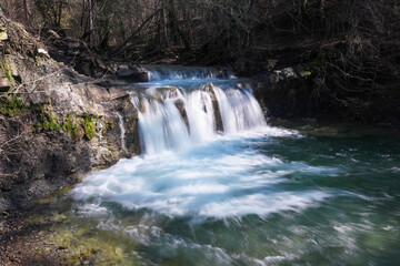 View of waterfall on Zhane river on sunny winter day. Krasnodar Krai, Caucasus, Russia.