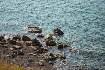 Stones washed by the Black sea in Crimea view from the shore