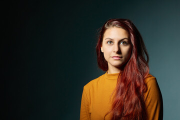 Portrait of beautiful young woman. Beauty portrait of multi-racial girl in orange sweater