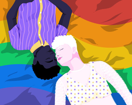 Overhead view of interracial couple laying down on LGBTQ flag 