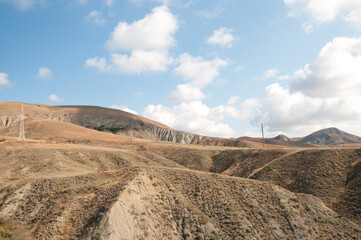 Landscape view of crimean steppe with picturesque hills and electric poles near Koktebel, Russia