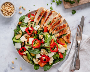 Mixed salad with grilled chicken courgette, red bell pepper, parmesan cheese and pine nuts