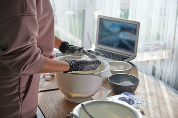 woman is taking an online lesson or watching a video on creating bath bombs. Online training, online classes. master creates handmade cosmetics