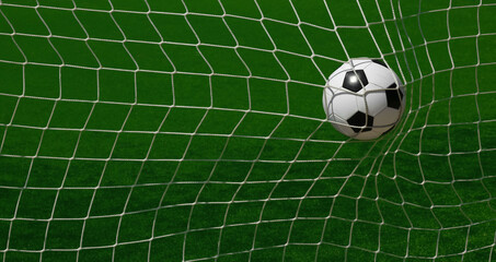 Fototapeta na wymiar Football ball scoring in goal net over green pitch