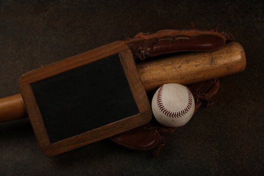 Baseball ball, wooden bat and vintage glove