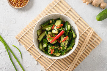 Asian spicy salad Broken Cucumbers with fresh coriander, ginger, pepper chili, black vinegar. Popular Chinese and Vietnam cold appetizer. Top view.