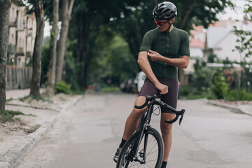 Cyclist sitting on bike outdoors and preparing for ride