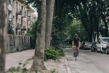 Fototapeta na wymiar Man in helmet using bike for cycling on asphalt road