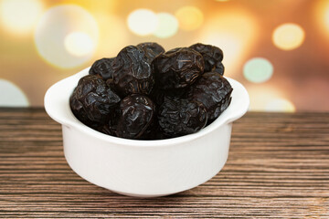 A bowl of Ajwa dates, popular during fasting month. Selective focus points. Blurred background