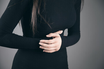a young woman has a stomach ache