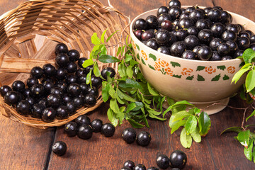Jabuticaba, Jabuticabas freshly harvested in pots and baskets arranged on rustic wood, selective focus.