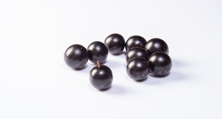 Jabuticaba, Freshly harvested Jabuticabas arranged over white background, selective focus.