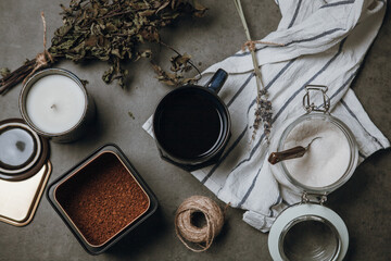 Flat lay photo of items for making coffee. Ground coffee in metal box, cup of black coffee, glass...