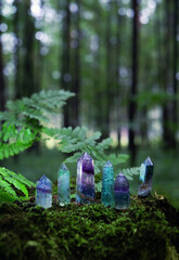 Gemstones minerals on mysterious natural forest background. Magic quartz crystals for esoteric...