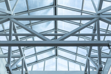 Steel frame of the glazed roof of a warehouse, shopping or office center. The ceilings are made of...