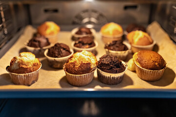 Baking vanilla and chocolate cupcakes in the oven