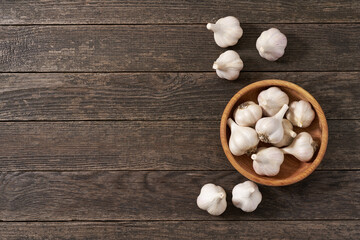 organic garlic on a wooden table, top view. Copy space for text.