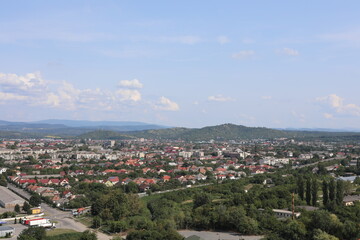 Naklejka premium view of the city. Scenic view of the town in the mountains on a cloudy summer day.