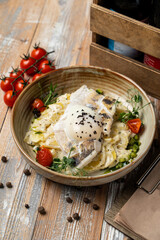 French fish gratin, gourmet hot meal in a restaurant, warm and cozy photo on wooden background