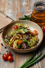Eggplant salad on a wide rustic plate, country-style photography, top view on a wooden background