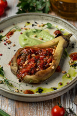 Eggplant stuffed with tomatoes and bell pepper, totally vegan meal in a restaurant, beautiful commercial photo