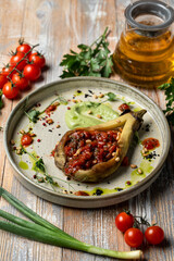 Eggplant stuffed with tomatoes and bell pepper, totally vegan meal in a restaurant, beautiful commercial photo