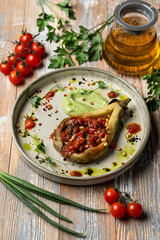 Eggplant stuffed with tomatoes and bell pepper, totally vegan meal in a restaurant, beautiful commercial photo