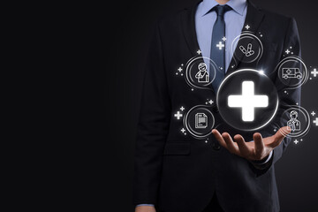 Businessman hold virtual plus medical network connection icons. Covid-19 pandemic develop people awareness and spread attention on their healthcare.Doctor,document,medicine,ambulance,patient icon.