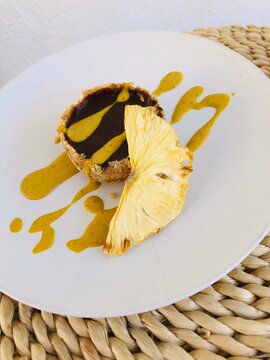 Individual vegan chocolate pineapple cake with a slice of pineapple