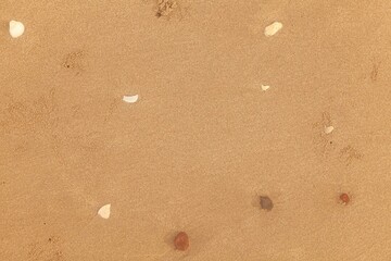 Fototapeta na wymiar Sand texture. Sandy beach for background. Top view. Natural sand stone texture background. sand on the beach as background. Wavy sand background for summer designs