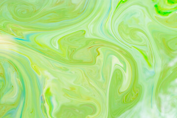 Green fluid art background. Liquid abstract pattern with UFO green. Marble texture of liquid surface. Fluid art