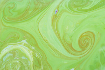 Green fluid art background. Liquid abstract pattern with UFO green. Marble texture of liquid surface. Fluid art