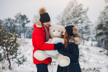 Loving couple walking in a winter park