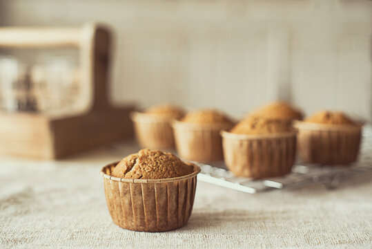 Home made muffins on a cooling rack on a table
