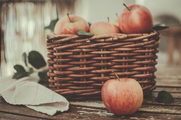 Red apples in a wicker basket on a table