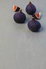 ripe figs on a stone table, copy space, vertical 