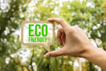 A woman holds a sign inside which the inscription - Eco Friendly. Ecology concept. Eco friendly and...