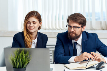 colleagues work together in front of laptop professionals technology